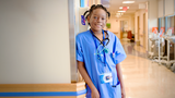 Wish kid Sophyii in a nurse uniform in a hospital hallway