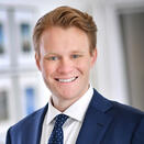 Brandon in a suit posing for his headshot