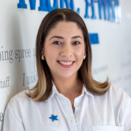 Liz Lopez, Southern Arizona Community Outreach and Referral Manager, standing in front of Wish Wall