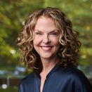 Belinda Marshall smiling and wearing a navy blouse