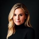 Elizabeth Dalton smiling and wearing a black turtleneck sweater