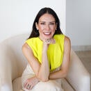 Patricia Finn Martillo smiling and wearing a yellow sleeveless blouse