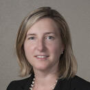 Tracy Yellen smiling and wearing a white shirt with black blazer