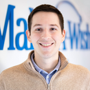 Kevin Fenton, Director of Operations, in front of Wish Wall