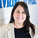 Marissa Astrain, Senior Director of Wish Delivery, standing in front of Wish Wall