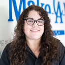 Rachel Shauger, Wish Coordinator, standing in front of Wish Wall