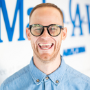 Sawyer Kilen, Wish Support Manager, in front of Wish Wall