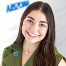 Daniela Rios, Community Outreach Manager for Central and Northern AZ, in front of the Wish Wall