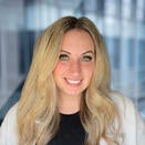 woman with long blond hair, white jacket and black top