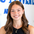 Halah Berglin, Events Specialist, in front of Wish Wall