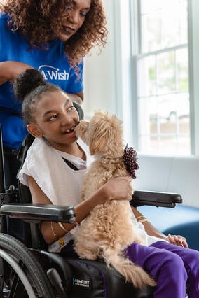 Wish kid Shanya with Volunteer Barbara and dog Fluffy