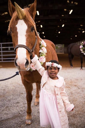 Gabby holds onto her unicorn.