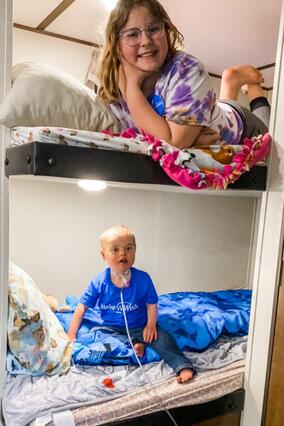 AJ in trailer with sister