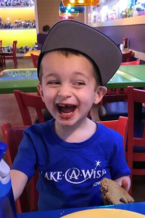 Henry enjoys a cookie after arriving at Give Kids The World.