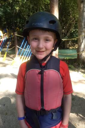 Liam in a helmet and life jacket