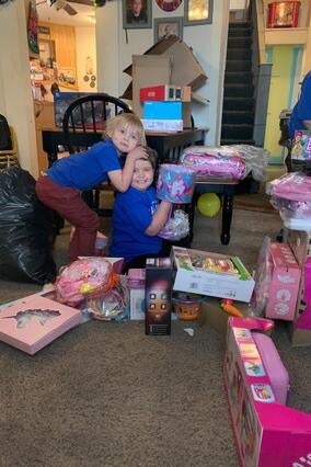 Penelope and her sibling opening up her gifts from her online shopping spree.