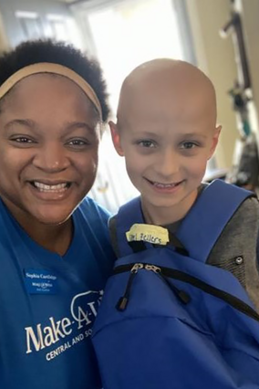 Volunteer Sophia with wish kid Steel