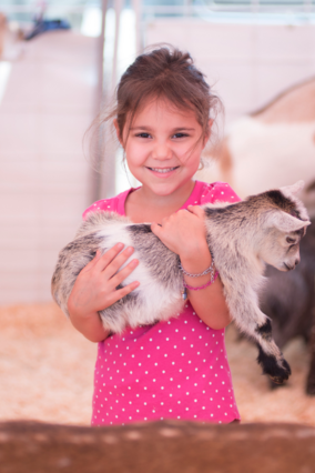 Wish kid Sabrina holding baby goat