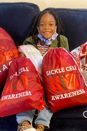 Amina with sickle cell awareness bags