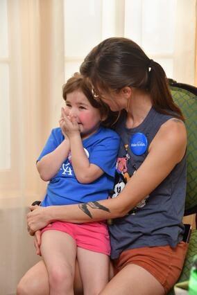 Sasha sitting in chair excited to meet Donald Duck