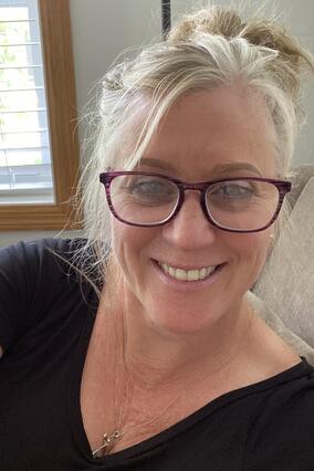 Betty smiling wearing glasses