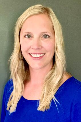 Lindsey smiling with blonde hair and blue shirt