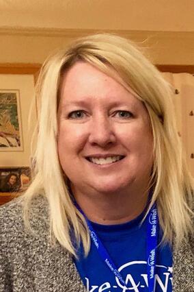 Diane smiling blonde in Make-A-Wish shirt