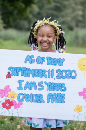 Aryn with cancer-free sign