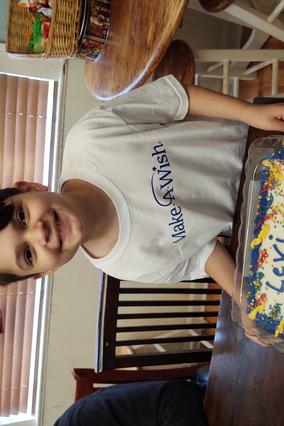 Wish kid Levi showing his wish day cake