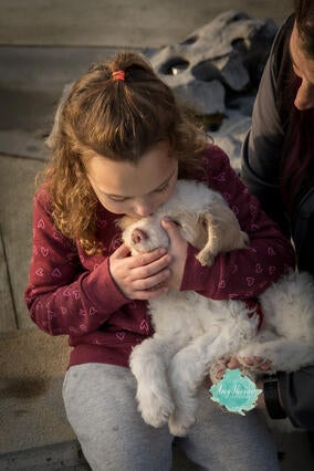 Emily kissing her new puppy Ryder