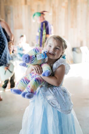 Addie hugging a stuffed animal.