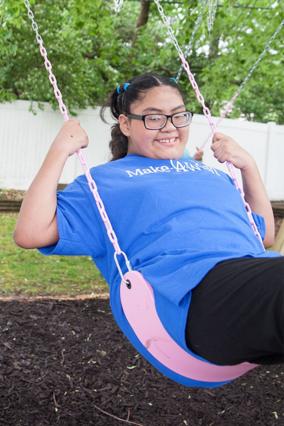 Luz smiling on a swing