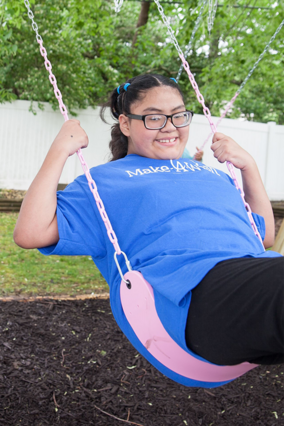 Luz smiling on a swing