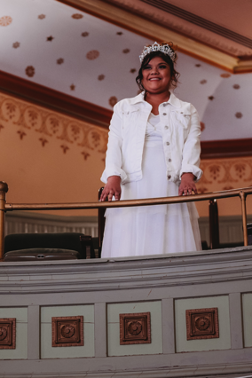 Wish child Gisselle in a white dress and jacket with a sparkly tiara