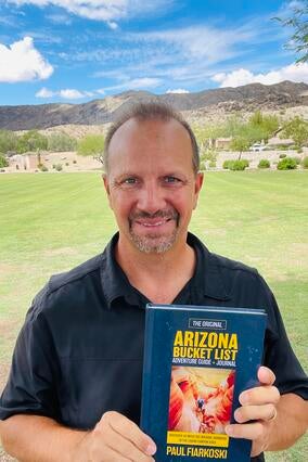 Paul with his book benefiting Make-A-Wish Arizona