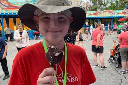 Edward enjoying a Mickey ice cream bar on his wish trip