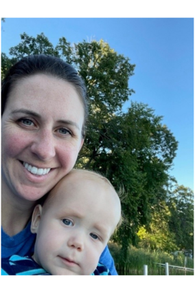 Rebecca and child smiling at dusk