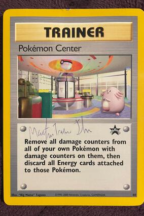 Exclusive Pokemon trainer card, autographed by staff from the Pokemon Center in New York