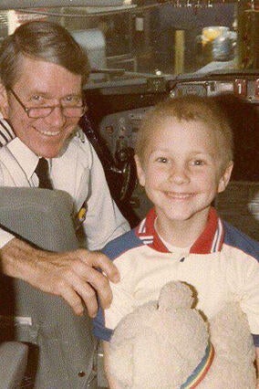 Bryan smiles big on the cockpit of the plane with the pilot.
