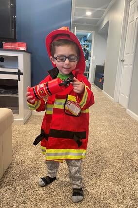 wish kid harrison dressed up as a firefighter