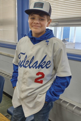 Miles standing wearing a blue and white jersey