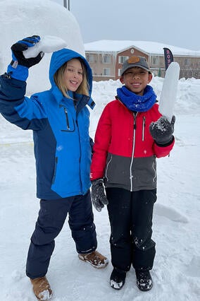 Yuval and Friend playing in snow