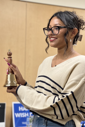 Gauri holding the cancer bell