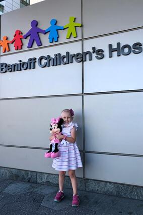 Alina holding her Minnie Mouse toy in 2020