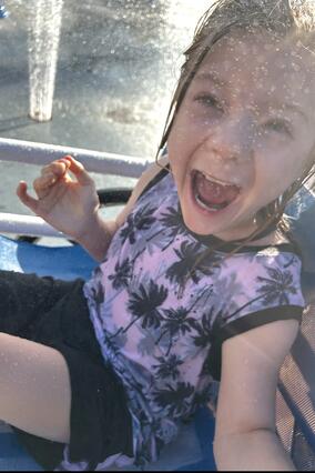Poseidon smiling and laughing covered in water riding during a ride