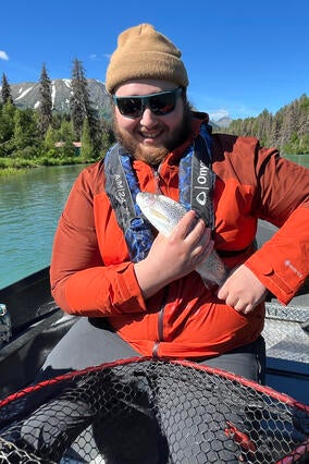 Teigan poses with a fish.