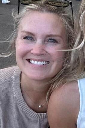 Anne Keller Smiling for the photo with sunglasses on her head