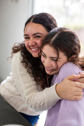Wish kid Antonia hugging younger sister