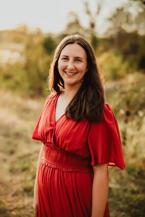 Betsy King in a red dress posing for the photo