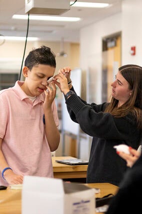 Jayden tests a prototype of an eye patch
